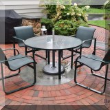L02. Round patio dining table and 4 chairs. 26”h x 48”w 